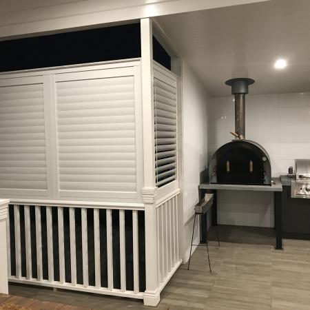 Create an extra living space by partially enclosing a verandah with Aluminium Shutters. 