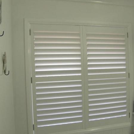 Stylish in white: Plantation Shutters look good in any location. Leah's Painted Shutters suits the white theme of the bathroom, creating a lovely feature window while keeping the privacy needed for the room. 