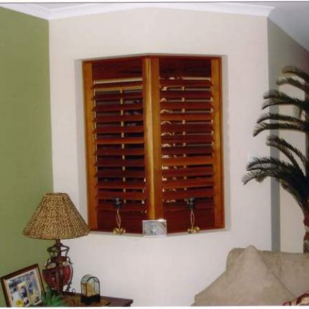 Shutters are a great way to fill an odd shaped opening.To achieve this elegant look the stiles (vertical parts) were cut on a 22.5 degree angle. Timber beading is also screwed into place to hold the shutters in the opening. Have you got a 