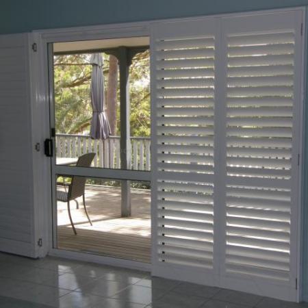 Stylish in white: Plantation Shutters look good in any location. Leah's Painted Shutters brightens the room dramatically and contrasts well against the dark furniture.