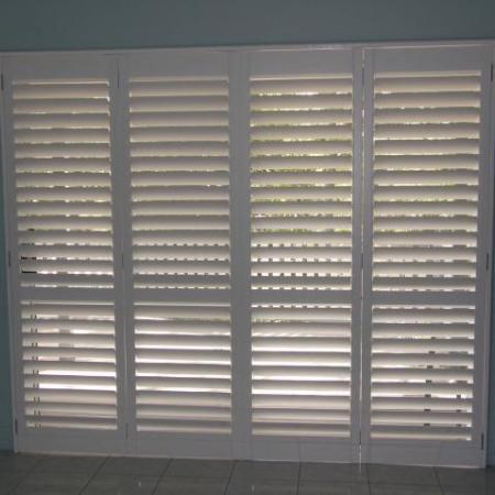 Stylish in white: Plantation Shutters look good in any location. Leah's Painted Shutters brightens the room dramatically and contrasts well against the dark furniture.