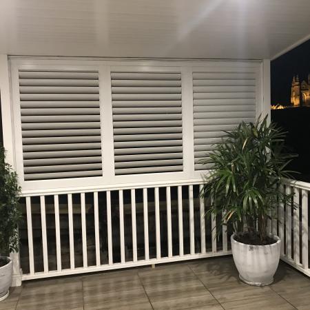 Create an extra living space by partially enclosing a verandah with Aluminium Shutters.